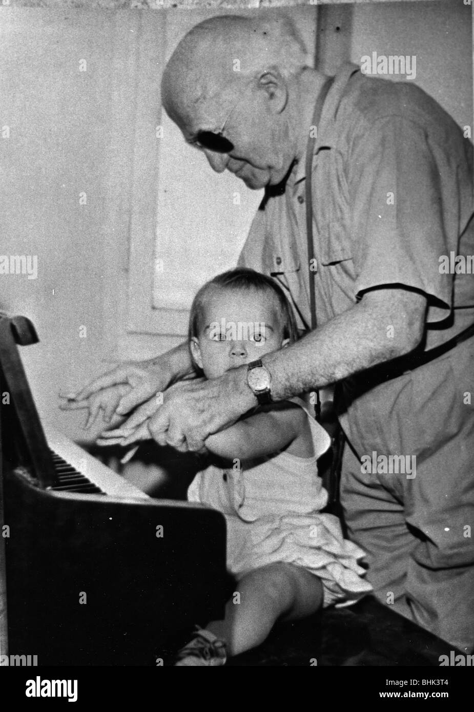 David Ben Gurion (1886-1973) trying to teach piano to his little granddaughter. Artist: Unknown Stock Photo