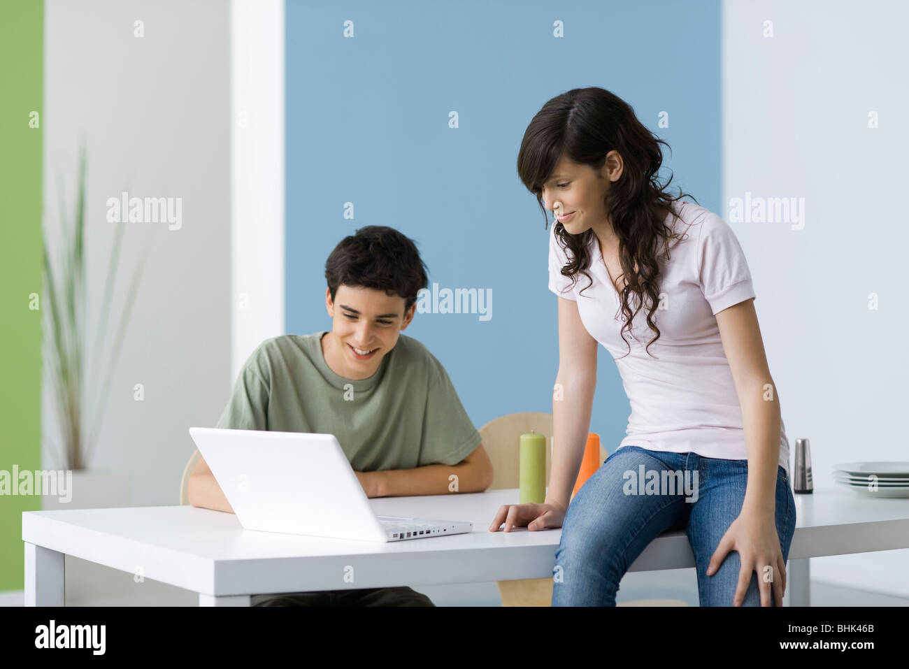 Teenagers hanging out using laptop computer together Stock Photo