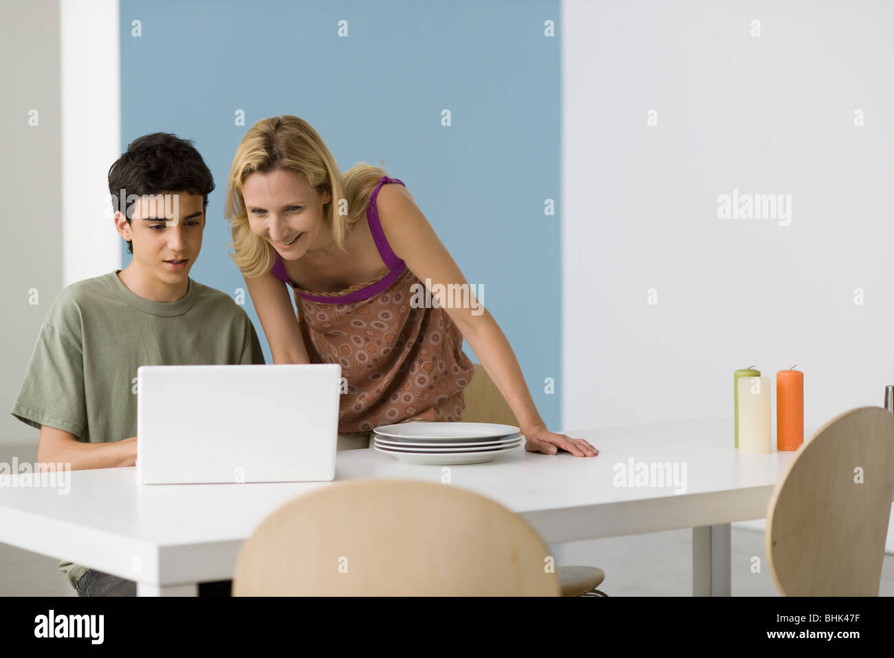 Teenage boy showing mother laptop computer Stock Photo
