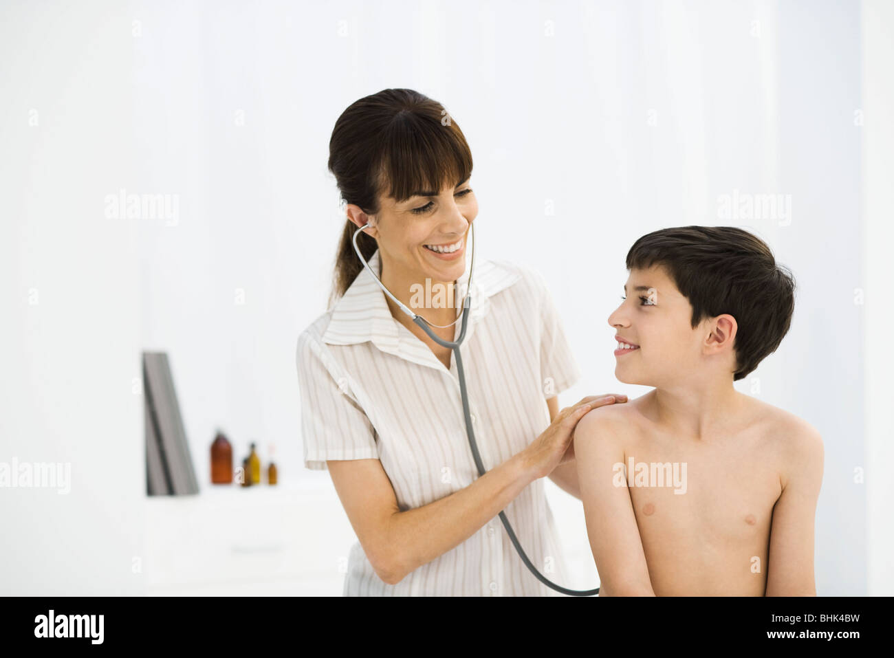 Pediatrician examining child Stock Photo