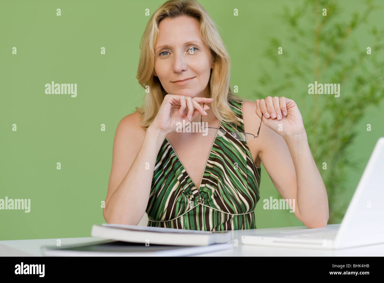 Mature woman with book and laptop computer, portrait Stock Photo