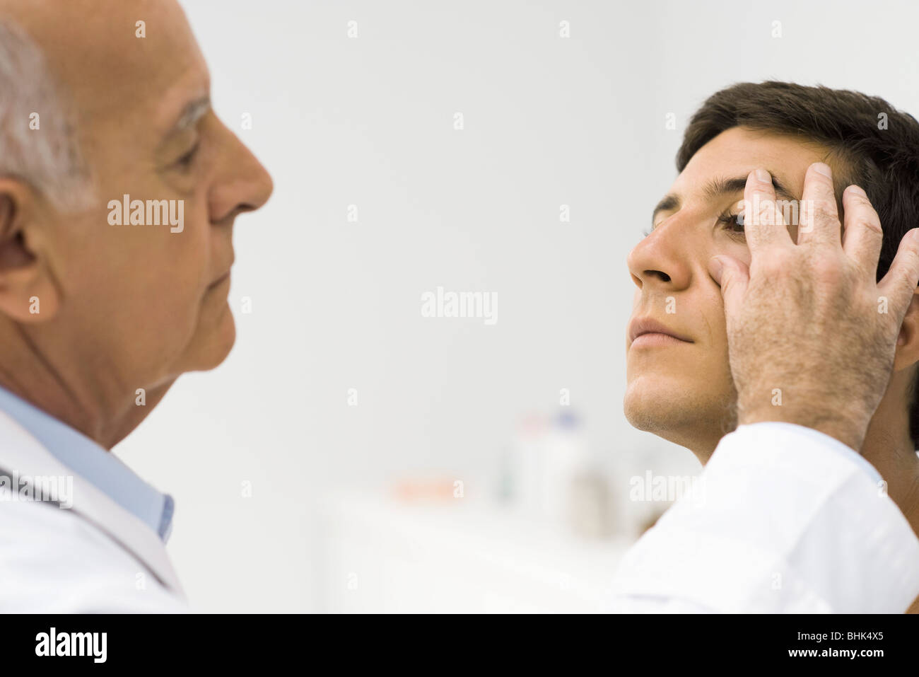 Doctor checking patient's ocular health Stock Photo