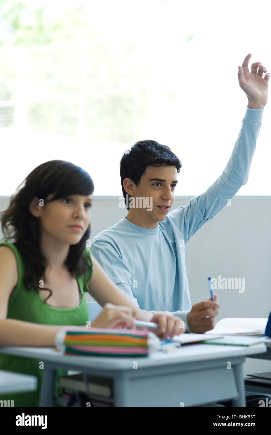 High school students in class, teen boy raising hand Stock Photo