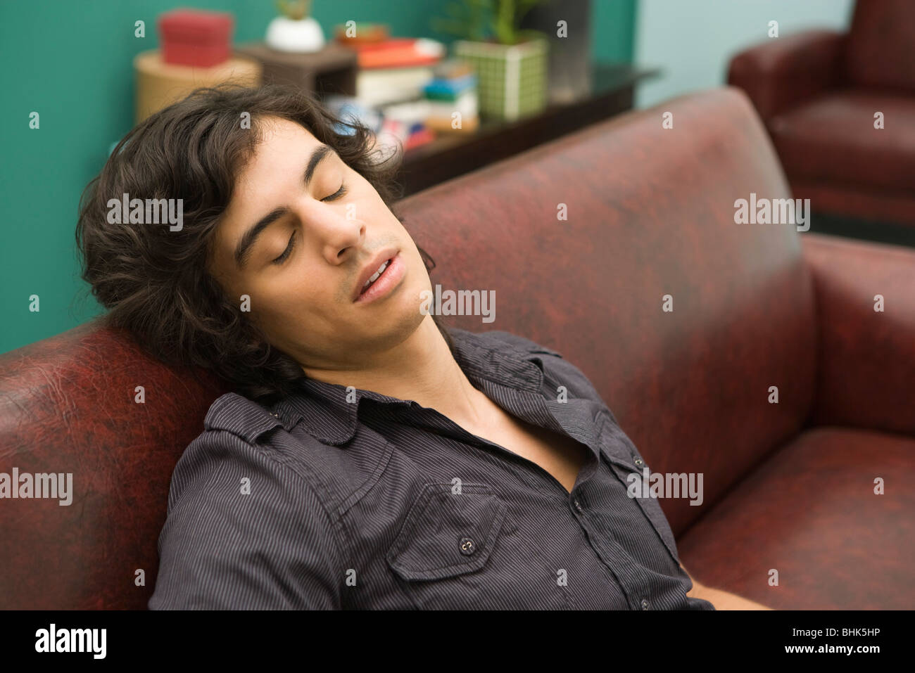 Young man dozing off to sleep on sofa Stock Photo Alamy