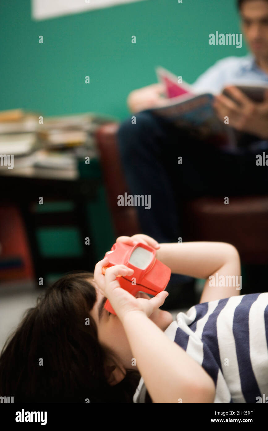 Child looking through toy viewfinder Stock Photo Alamy