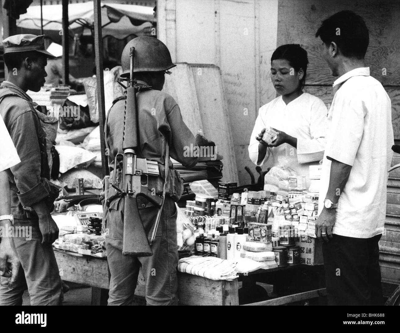 geography / travel, Vietnam, Phan Rang, street scenes, soldier shopping at a stall, 1972, soldiers, military, South-East Asia, Southeast Asia, Second Indochina War, 20th century, historic, historical, 1970s, 70s, Vietnam War, uniform, uniforms, assault rifle, M16, M 16, trader, traders, people, woman, men, trade, women, female, Stock Photo
