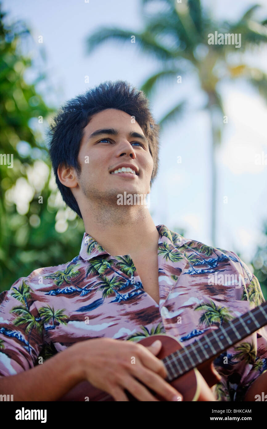 portrait of a pacific island man playing a ukulele in hawaii Stock