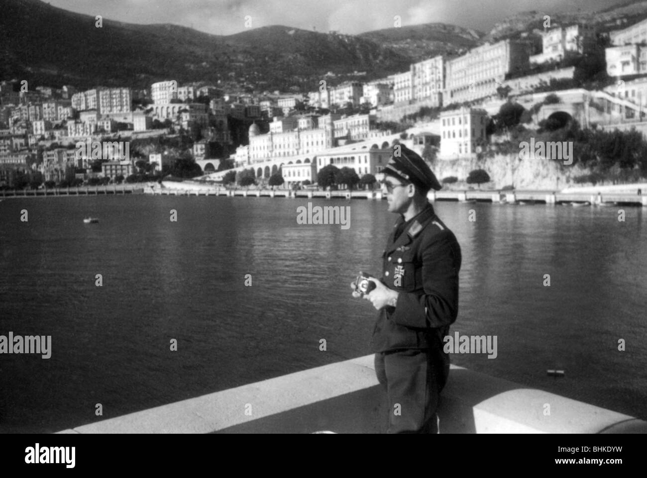 geography / travel, Monaco, politics, Italian and German occupation 1942 - 1944, German Luftwaffe war correspondent at the coast, probably May 1943, Germany, Second World War, WWII, 20th century, military, uniform, uniforms, historical, historic, city views, cityscapes, houses, principality, half length, soldier, photographer, Wehrmacht, Third Reich, 1940s, people, Stock Photo