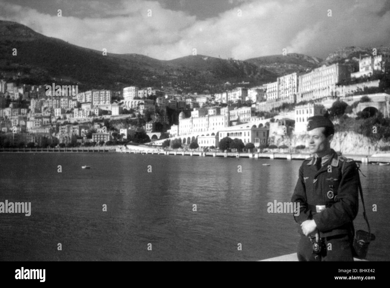 geography / travel, Monaco, politics, Italian and German occupation 1942 - 1944, German Luftwaffe war correspondent at the coast, probably May 1943, Germany, Second World War, WWII, 20th century, military, uniform, uniforms, historical, historic, city views, cityscapes, houses, principality, half length, soldier, photographer, Wehrmacht, Third Reich, 1940s, people, Stock Photo