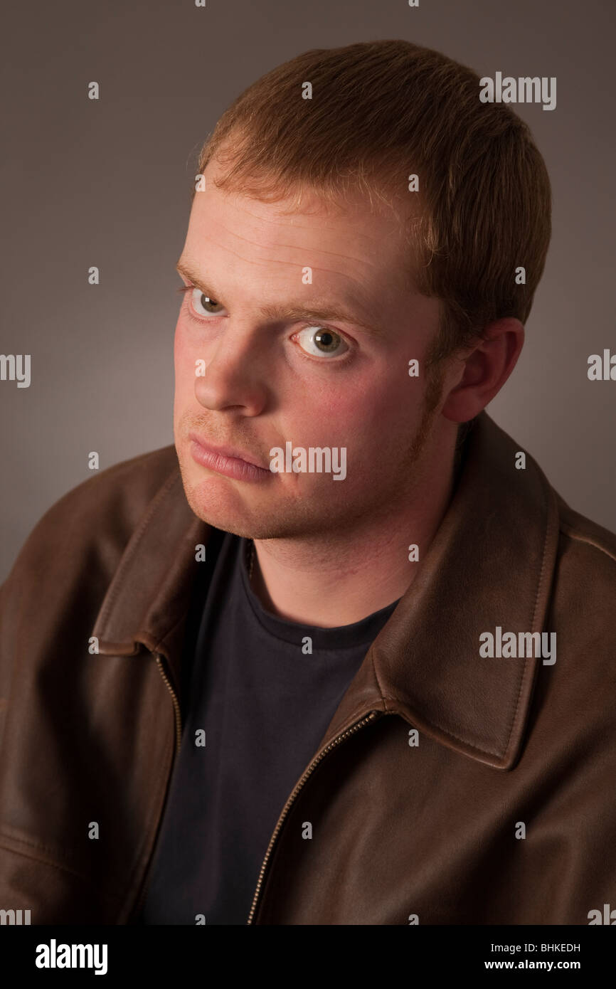 A young man in his twenties with a serious expression Stock Photo