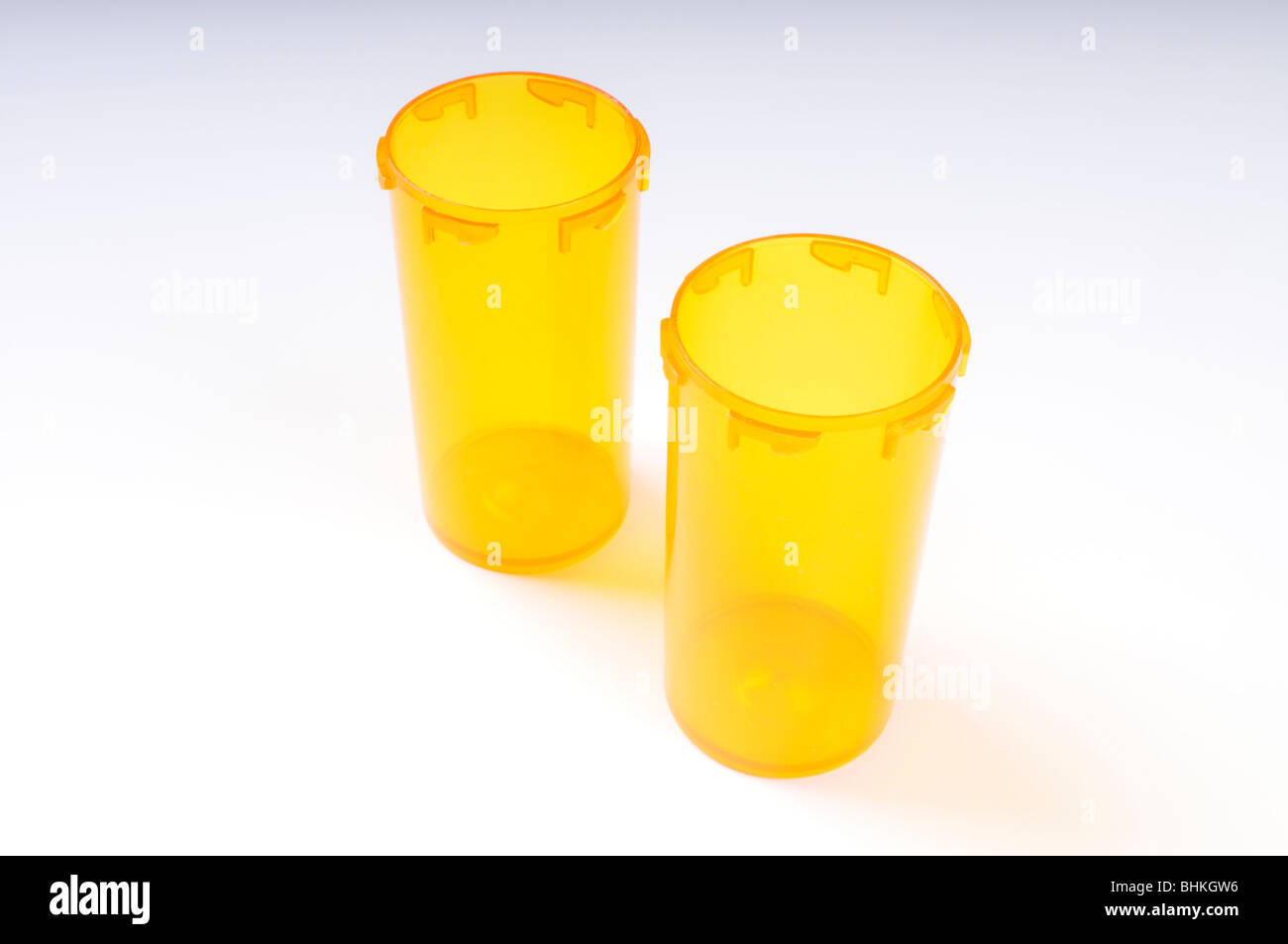 2 empty prescription pill bottles without covers and no labels on white background. Stock Photo