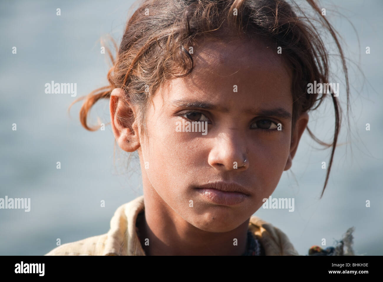 Portrait of Indian girl selling flowers at Maheshwar temple,India. Stock Photo
