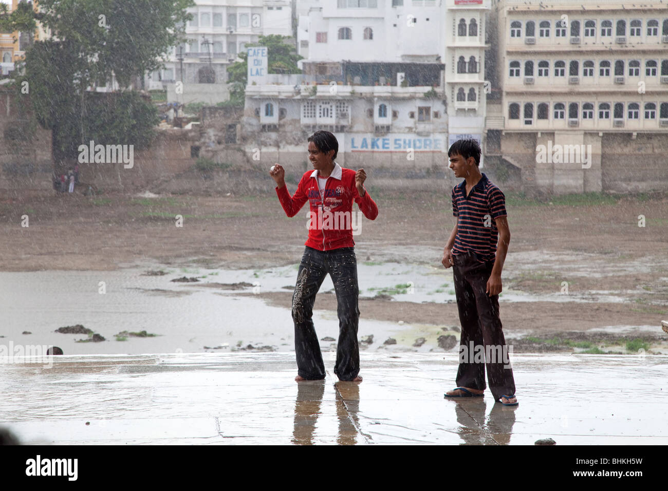 India Rajasthan Udaipur Teenage boys celebrating arrival of early monsoon rain Stock Photo