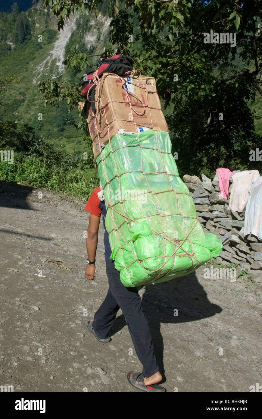 Porter carrying heavy load, Bagarchhap Annapurna Circuit, Nepal