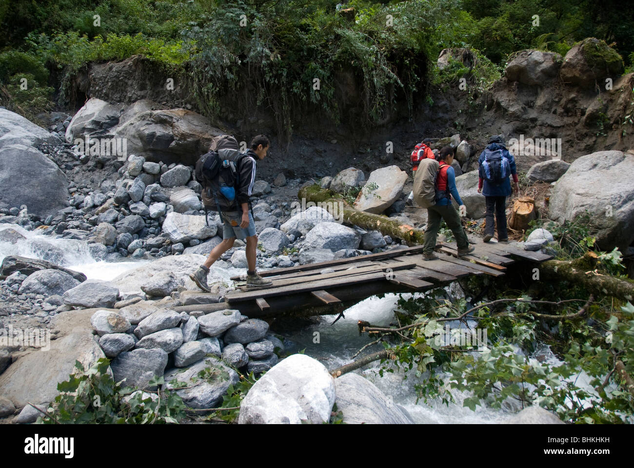 Trekkers crossing makeshift footbridge near Bagarchhap, Annapurna ...