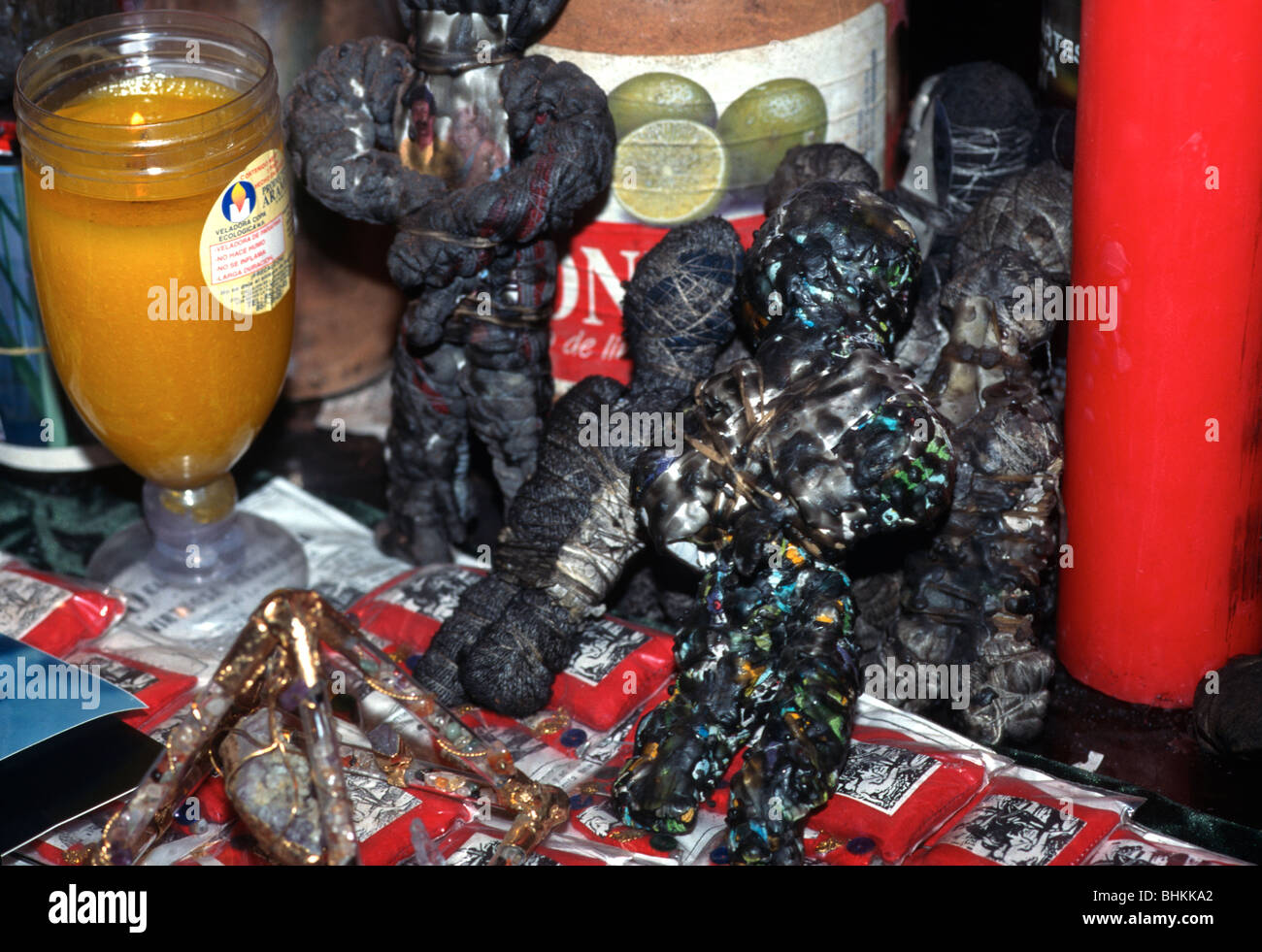 Items on the table of a brujo (witch doctor), including voodoo dolls, candles, spell potions and a pentacle, Catemaco, Mexico. Stock Photo