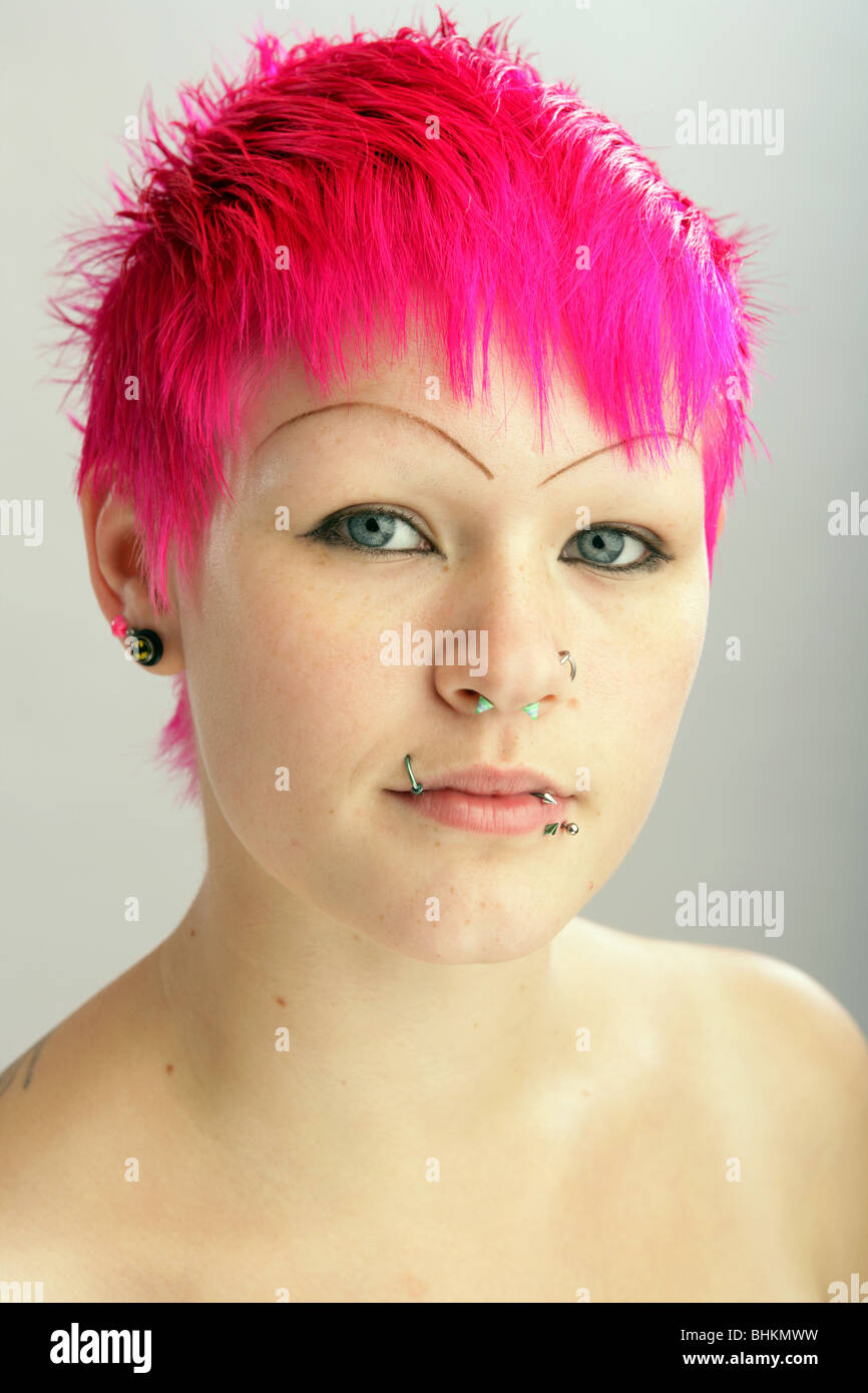 Portrait of a 19 year old girl with dyed pink / red hair. Stock Photo