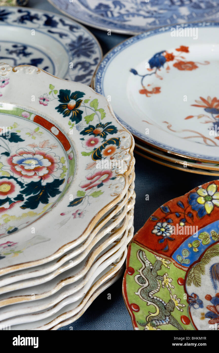 Antique plates, English and Chinese, laid out for sale on a dealer's table  Stock Photo - Alamy