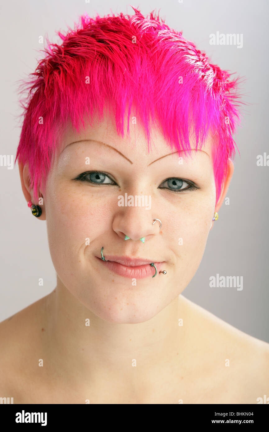 Pretty young woman with bright dyed hair looking at camera. Stock Photo