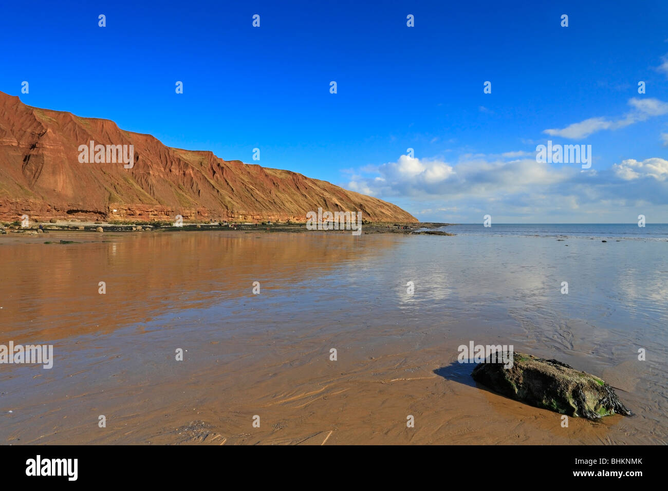 Filey Brigg natural rock promontory from the beach, Filey, North Yorkshire, England, UK. Stock Photo