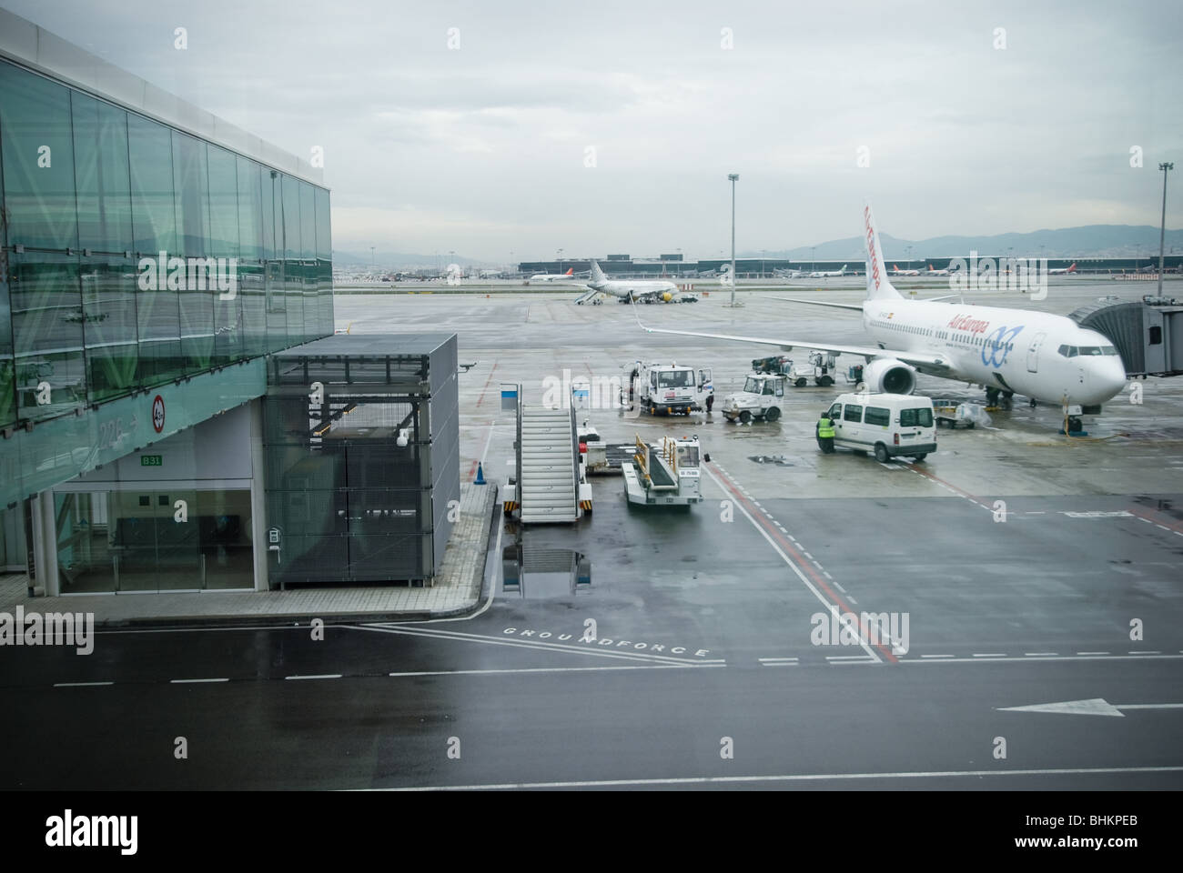 A plane is serviced and loaded with passengers before a flight. Stock Photo