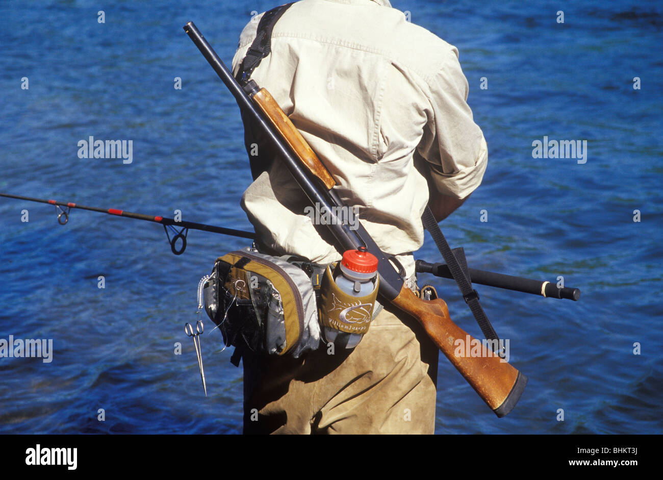 A fishing guide on River Talachulitna with a shot gun as protection against  Bears Stock Photo - Alamy