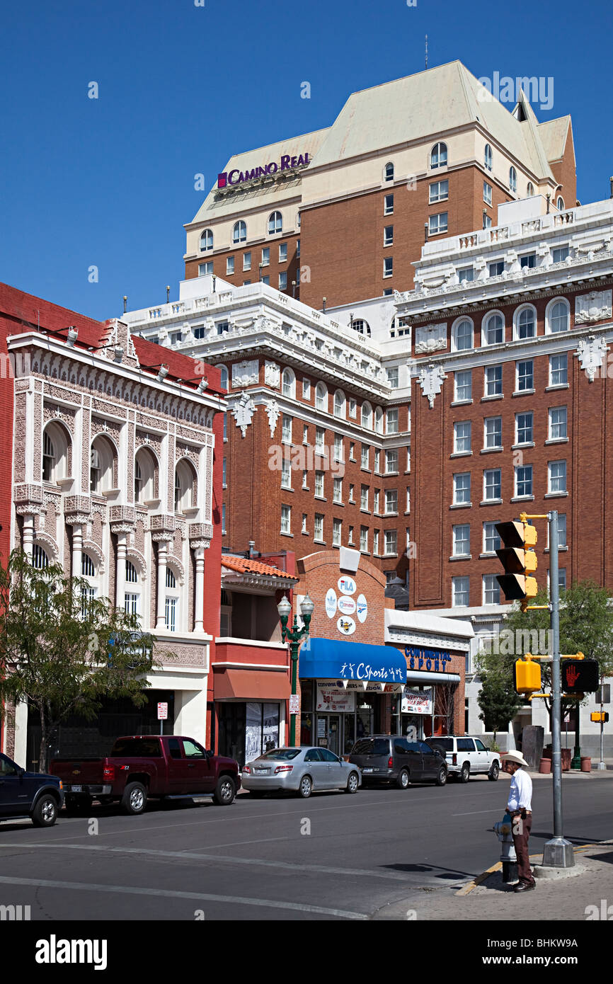 Man in hat standing on street corner with shops and hotel El Paso Texas USA Stock Photo