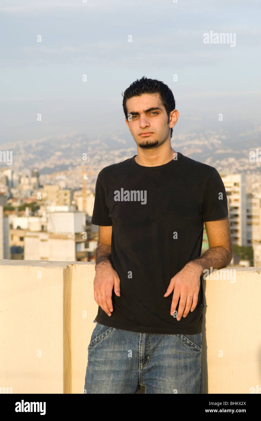 Serious Arabic teenager boy standing outside Stock Photo - Alamy