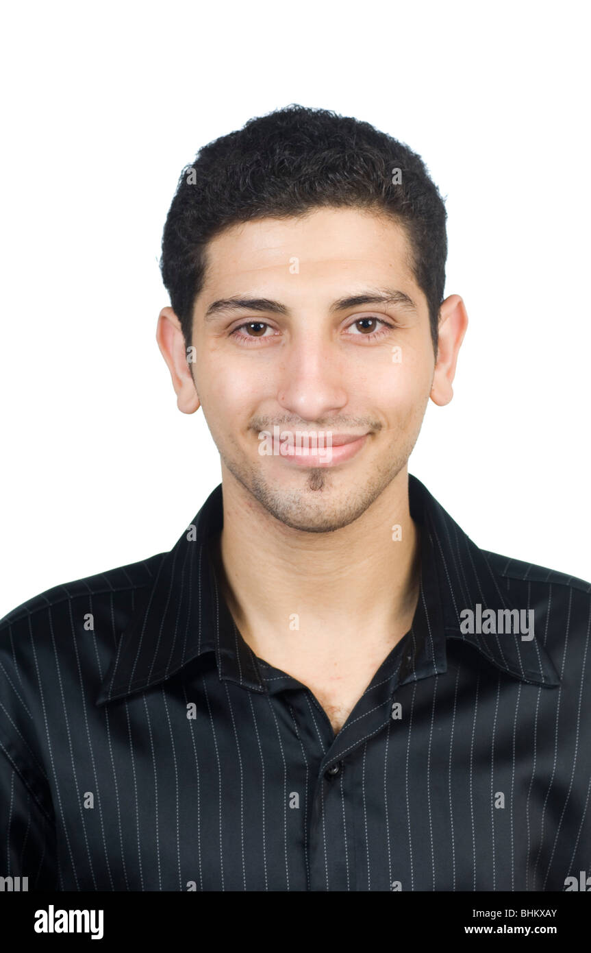Portrait of a happy young man looking at the camera smiling against a ...