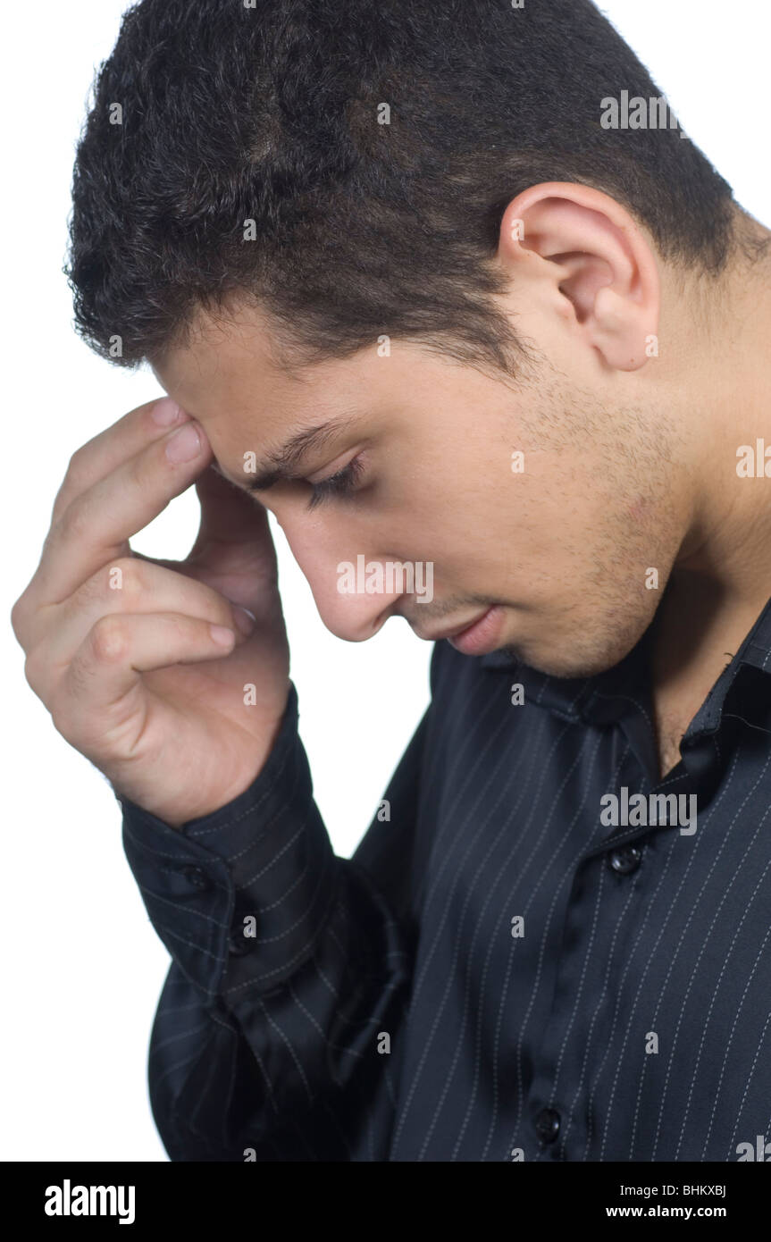 Young Asian man in black shirt head in hands trying to remember something against a white background Stock Photo