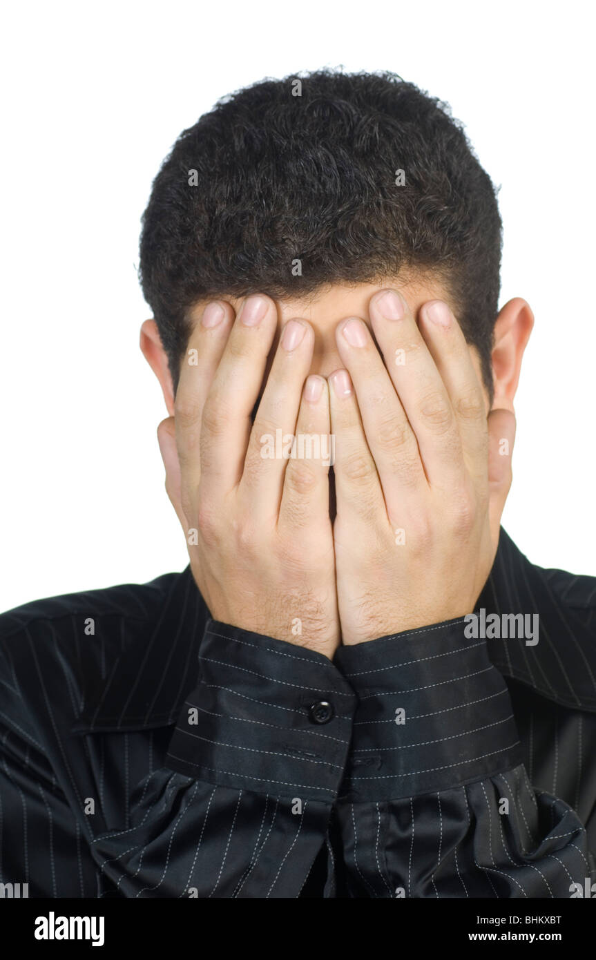young man head in hands hiding his face Stock Photo