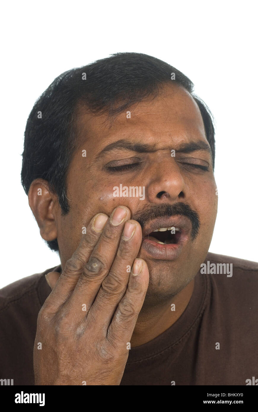 Indian man hand over mouth with tooth pain Stock Photo
