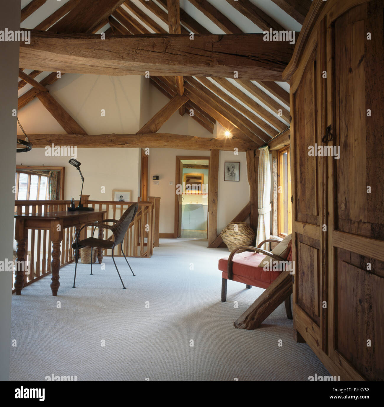 White carpet on landing of barn conversion with beamed apex ceiling