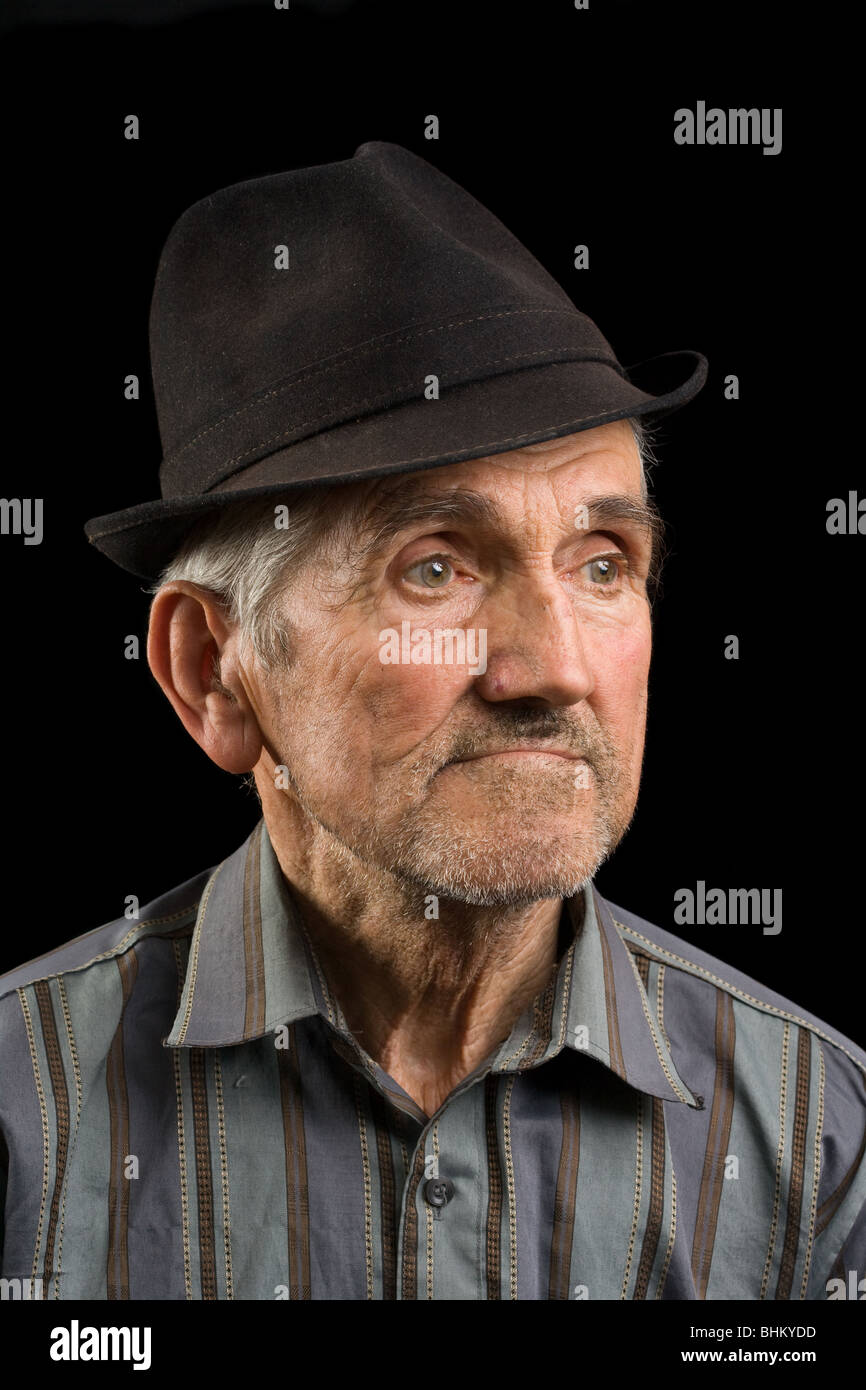 Portrait of an old man with hat isolated on black Stock Photo - Alamy