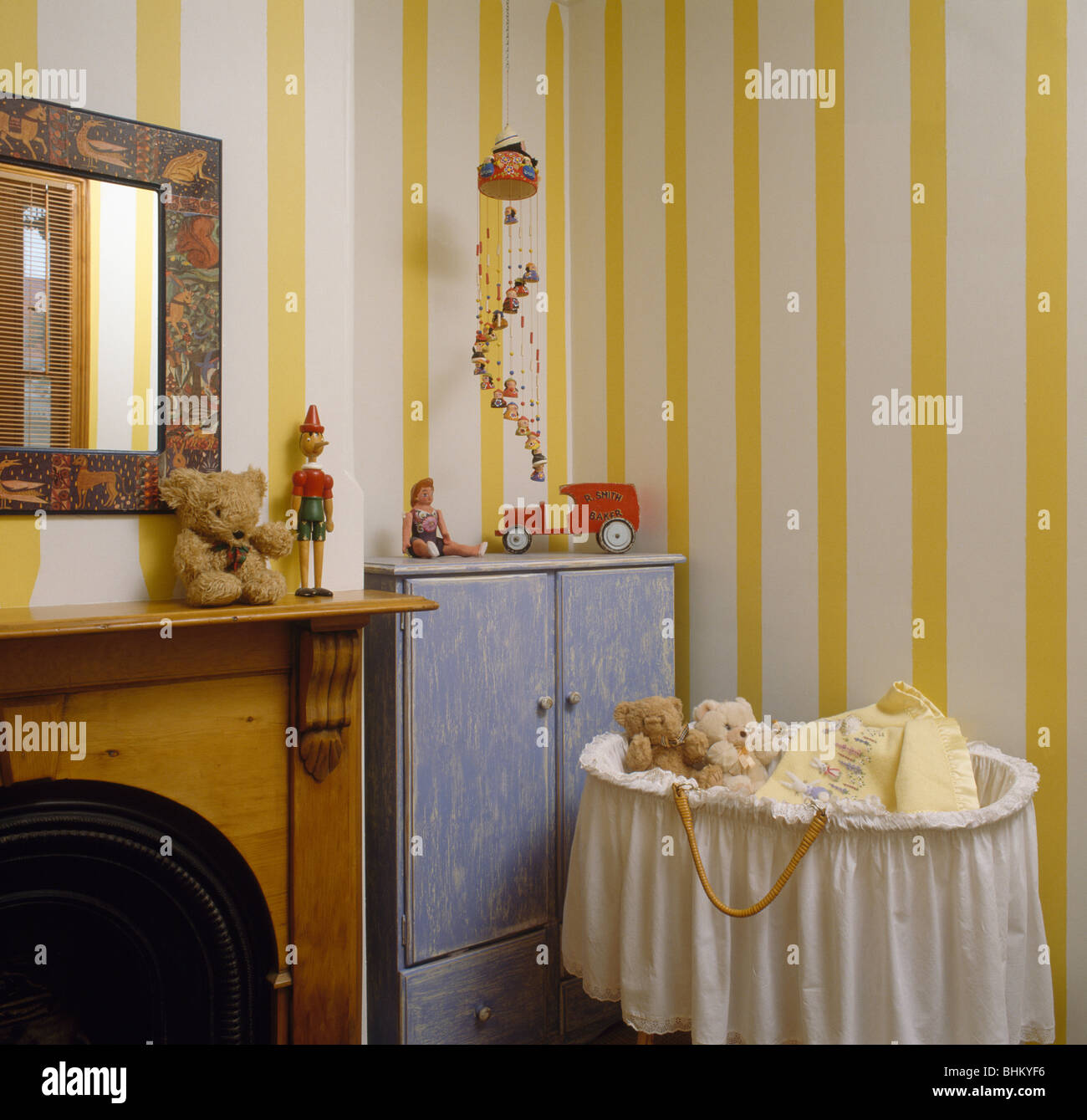 Wide Striped Yellow Wallpaper And Blue Cupboard In Nursery