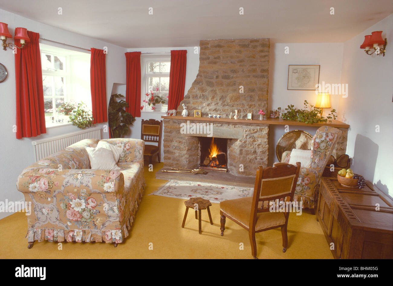 Floral Loose Cover On Sofa In Front Of Stone Fireplace With