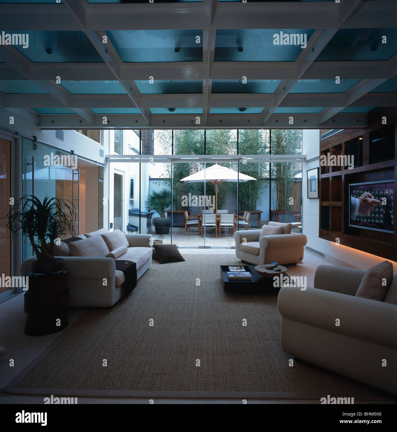 Cream sofas in large openplan modern white living room with cream