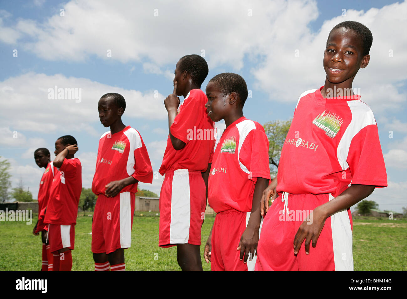 A soccer team of Black South African schoolboys posing for an informal