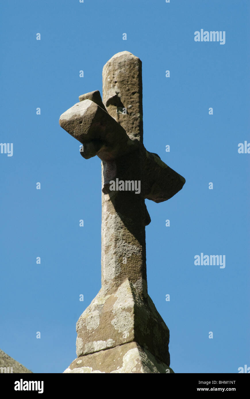 A stone cross on a church steeple. Stock Photo