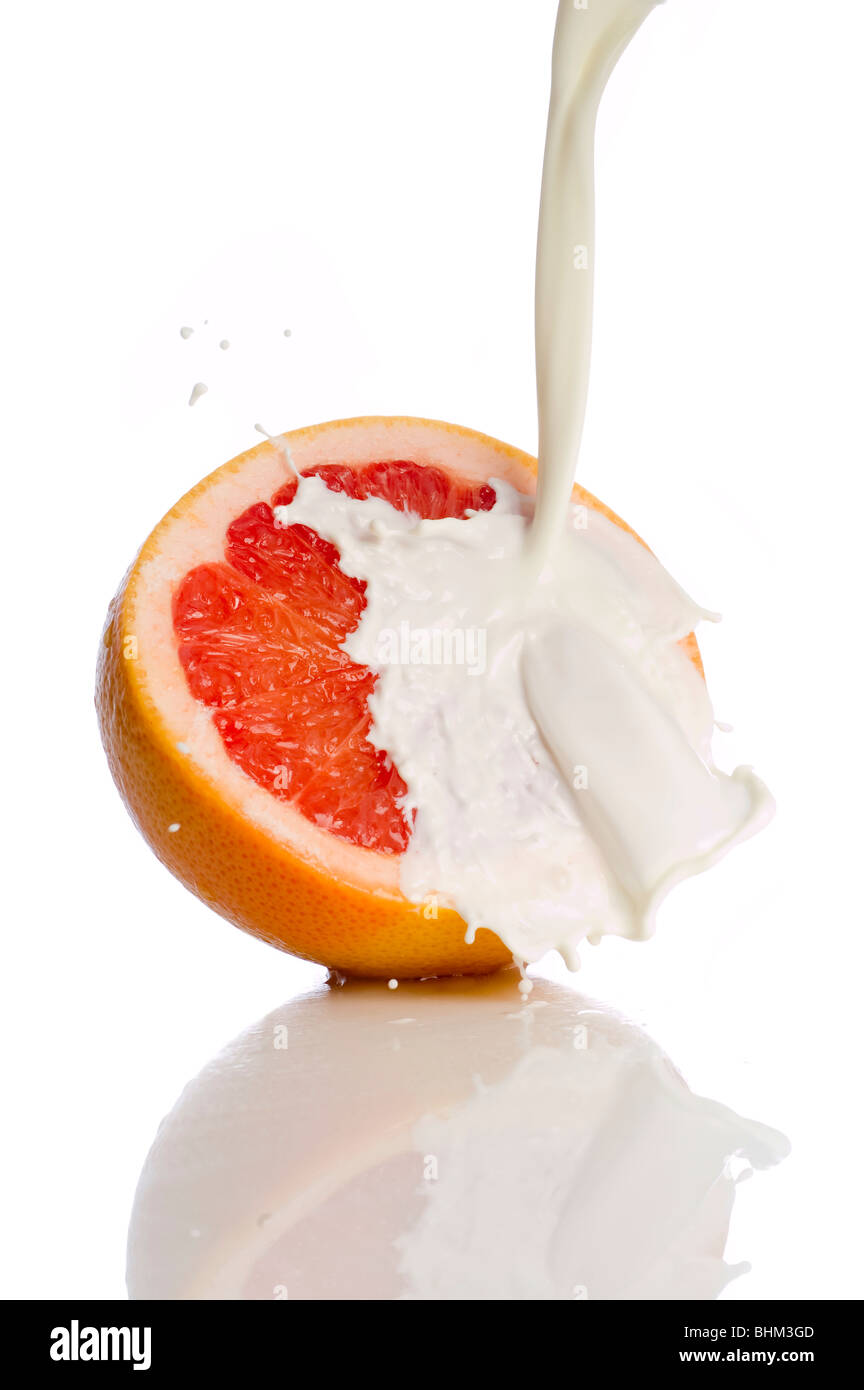 grapefruit with splashing milk Stock Photo Alamy