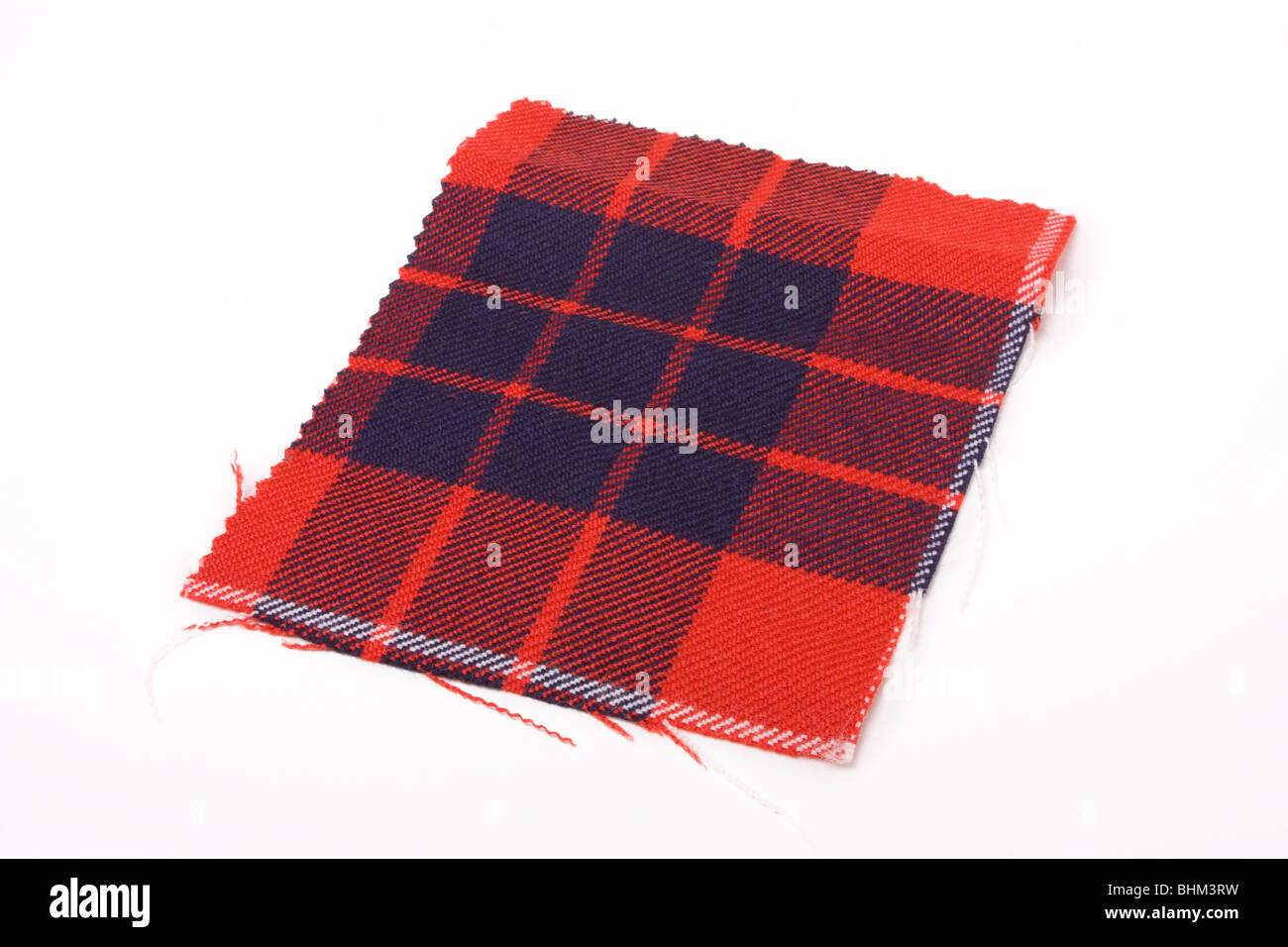 A swatch of red and blue tartan cloth against white background. Stock Photo