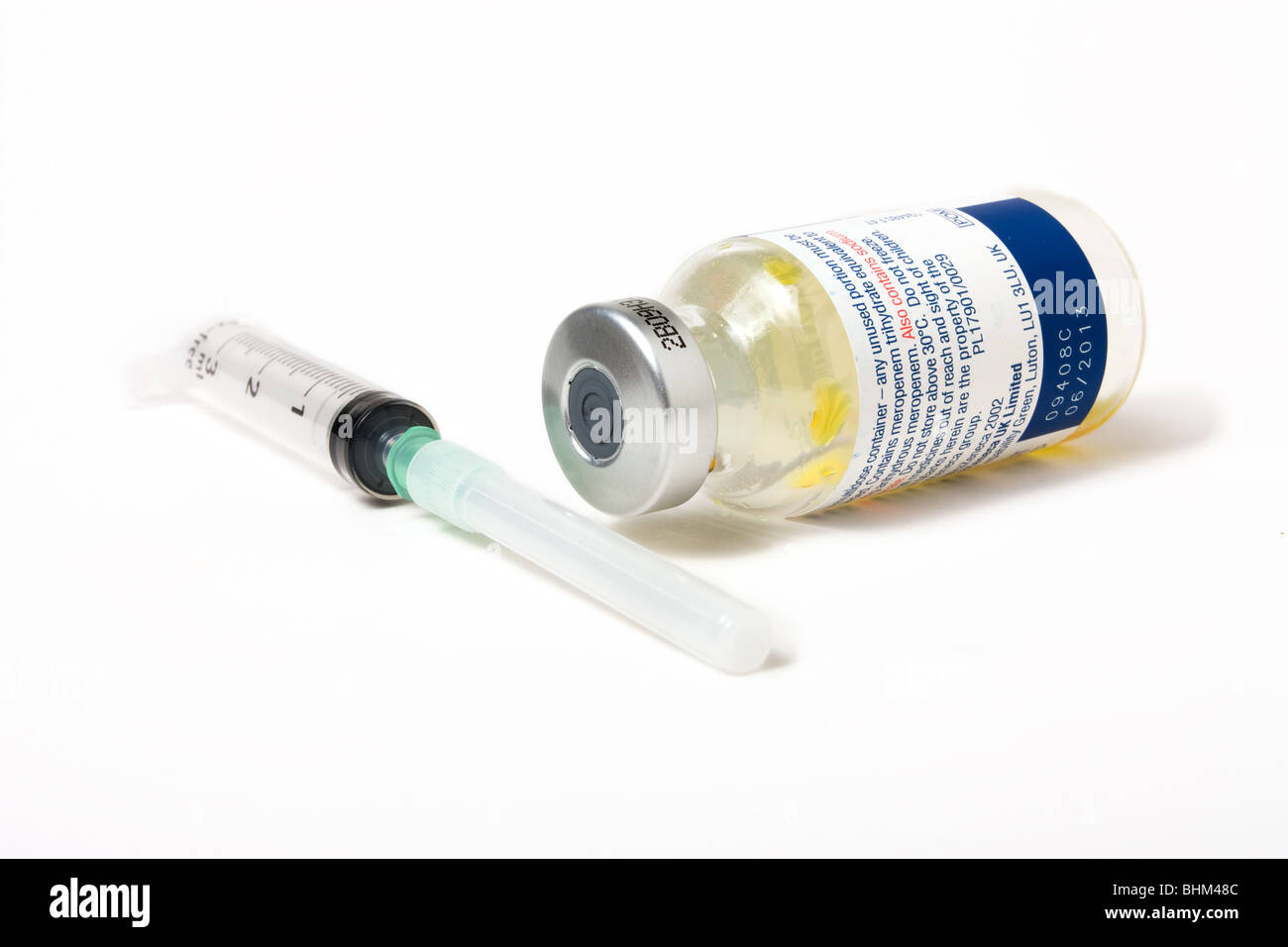 Syringe with hypodermic needle and metal topped glass closed vial drugs bottle Stock Photo
