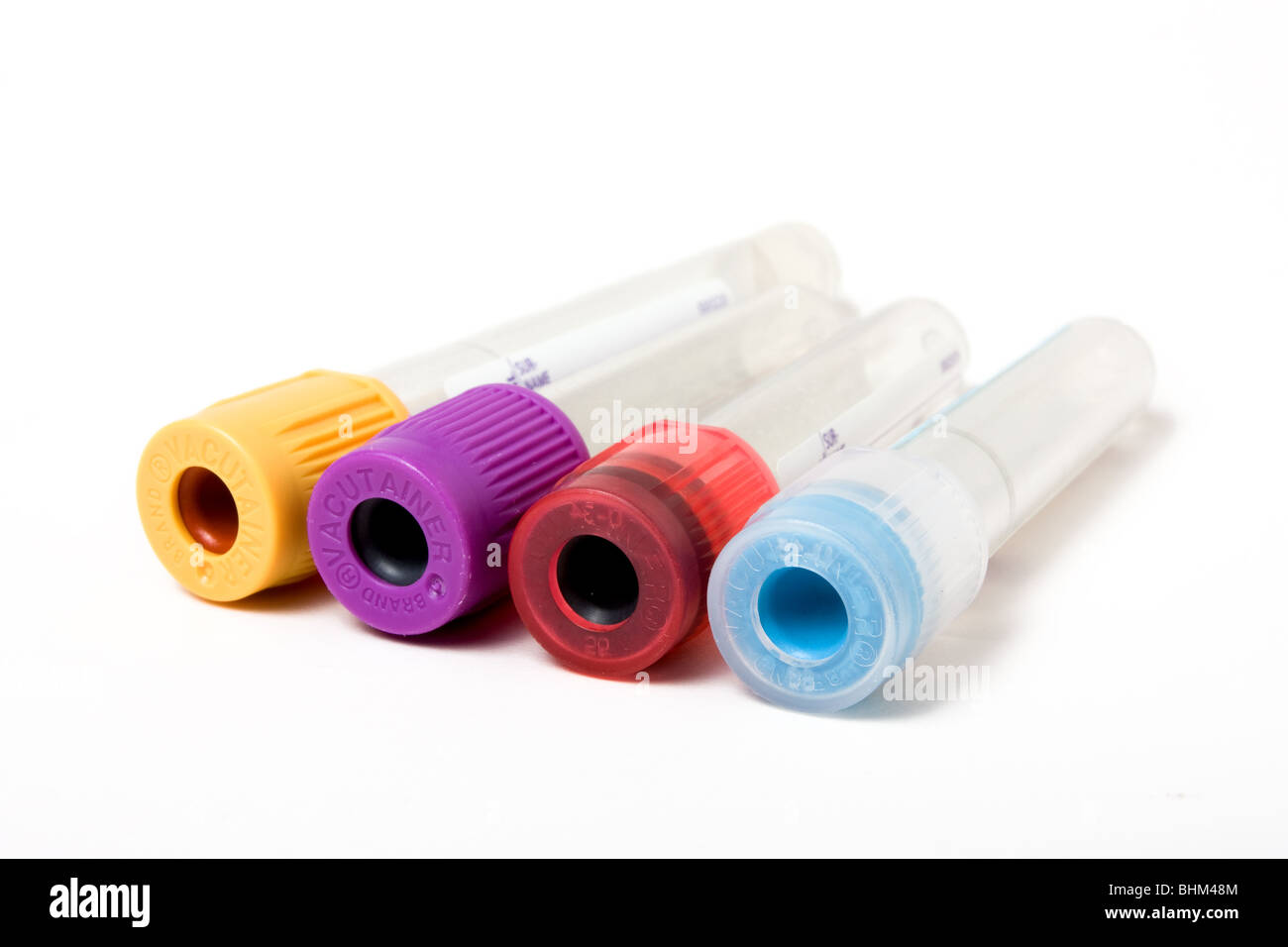 Colour coded blood sample tubes isolated against white background Stock