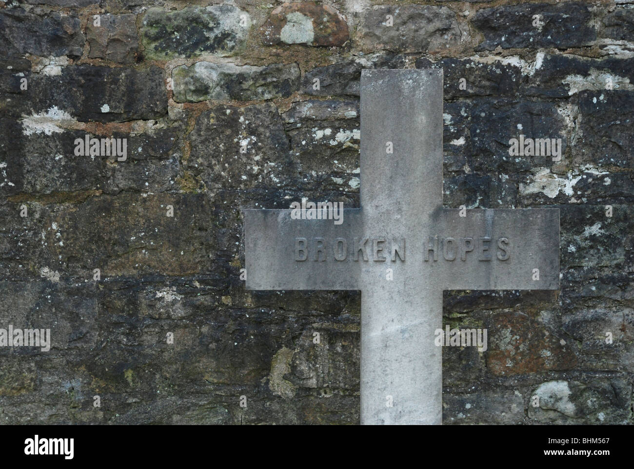 A cross with the inscription 'Broken Hopes' Stock Photo