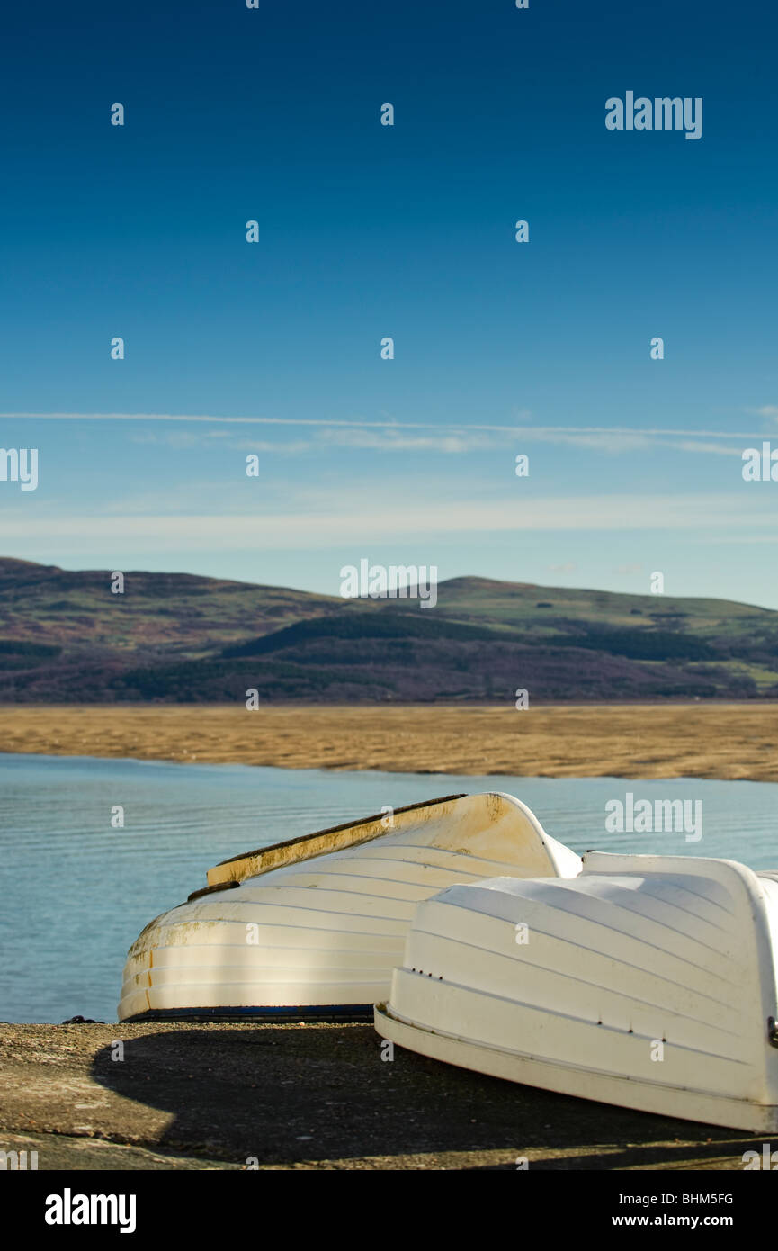 Two upturned rowing boats at Aberdyfi Aberdovey, Dyfi estuary,  Gwynedd north wales UK Stock Photo