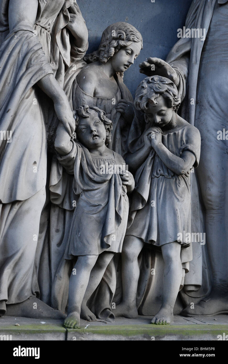 Detail from a statue of a Victorian family group in St Cuthbert's Churchyard Edinburgh Stock Photo