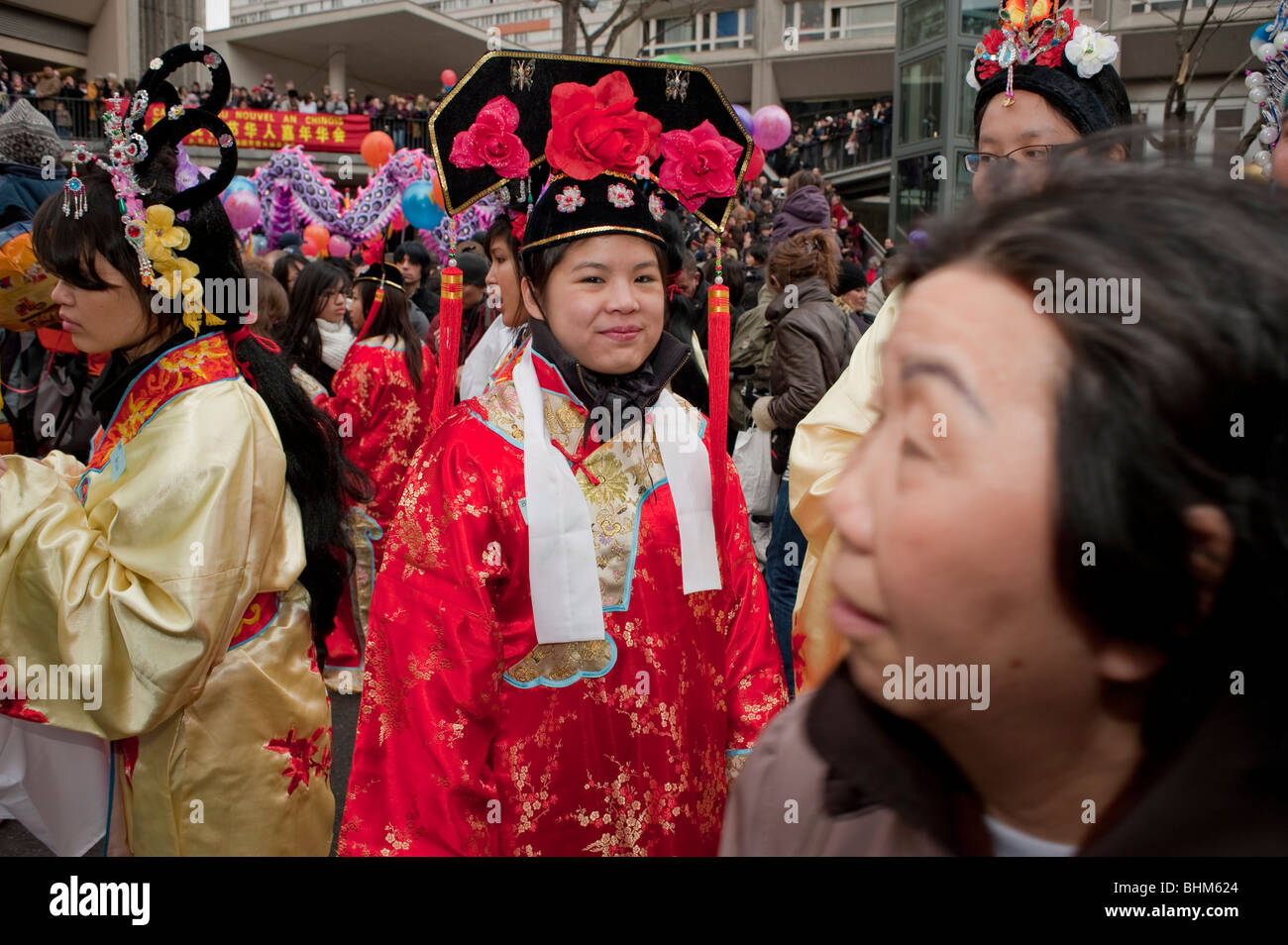 Paris, France, Large Crowd People, Chinese Women Dressed in Traditional Chinese Dresses, red chinese silk in 'Chinese New Year' Carnival in Chinatown, young woman in a crowd Stock Photo