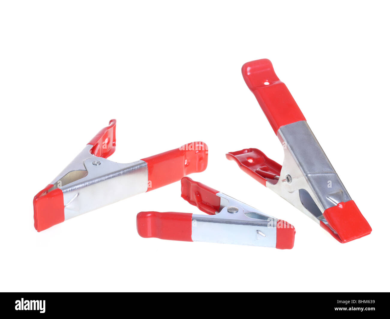Three metal clamps over white background Stock Photo