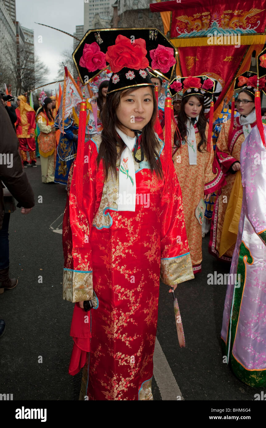 Paris, France, Portrait Young Chinese young woman in a crowd Standing on Street, Posing in Traditional Dress in  Chinese New Year Celebrations, red chinese silk Stock Photo