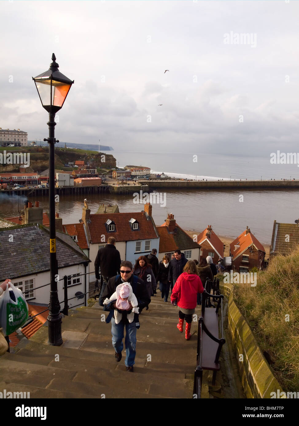 Holidaymakers on the famous 199 steps from the town to St Marys church and the Abbey, Whitby North Yorkshire, UK Stock Photo